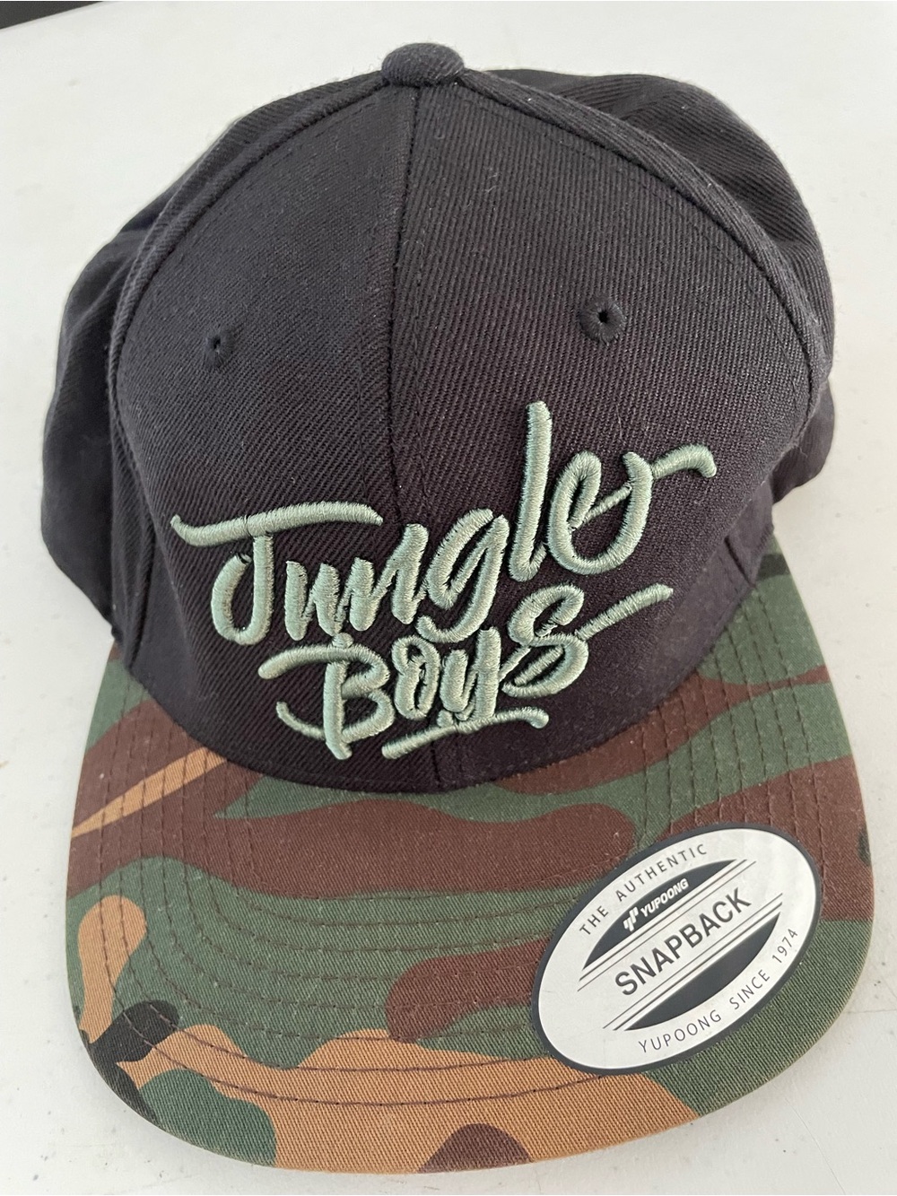 Mens Stylish Jungle Boys Logo Snapback Cap - Black with Camouflage Brim.